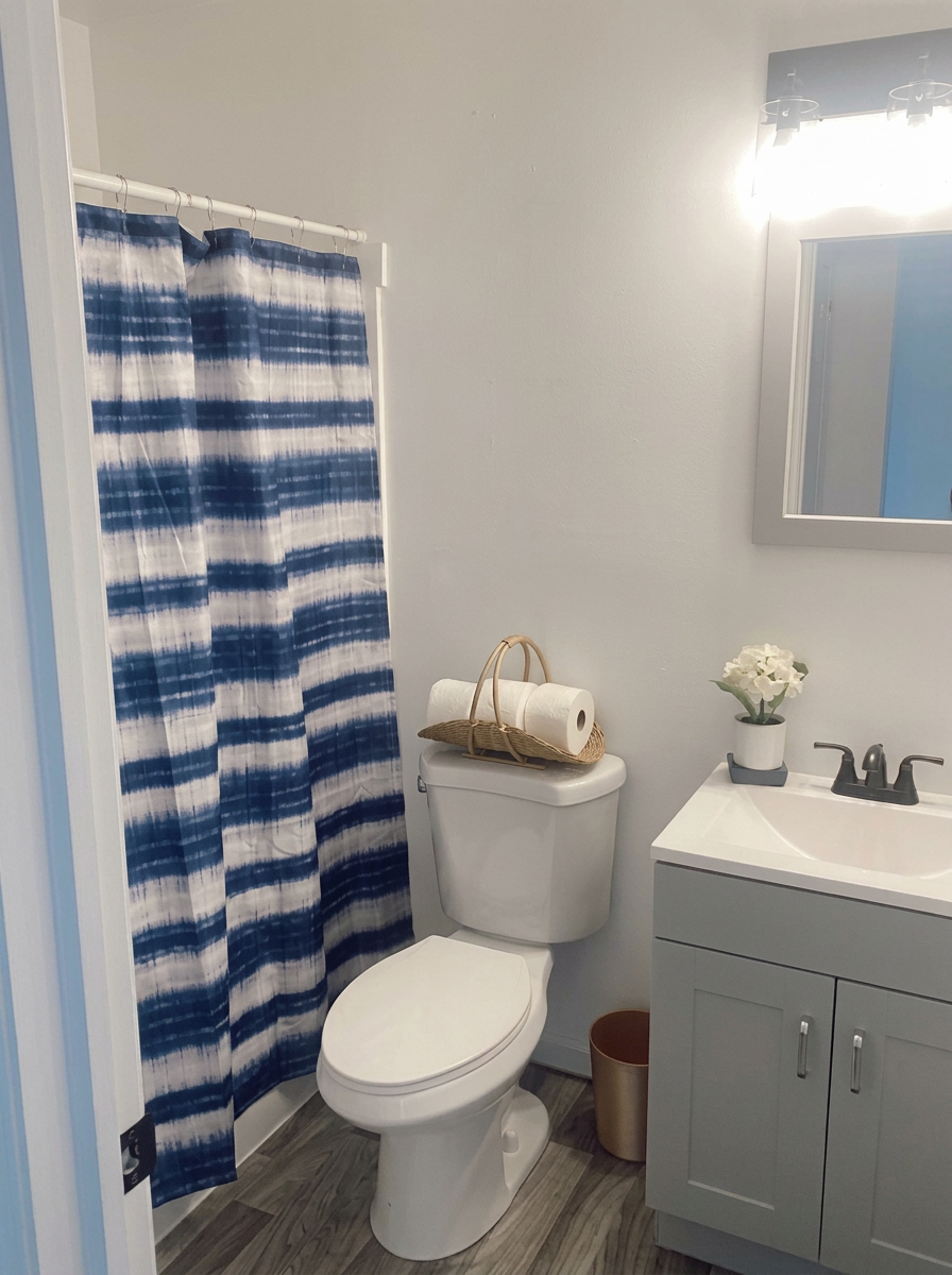 Updated bathroom with new gray vanity, flooring and fixtures