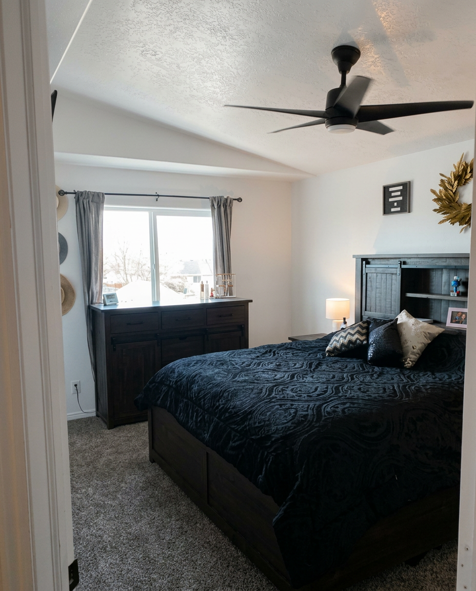 Remodeled master bedroom with new carpet, ceiling fan and finished walls
